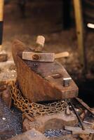 Forge, hammer on an anvil standing on the street photo