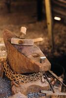 Forge, hammer on an anvil standing on the street photo