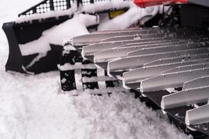 Metal tracks of a snowplow car in winter in the snow photo