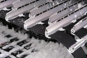 Metal tracks of a snowplow car in winter in the snow photo