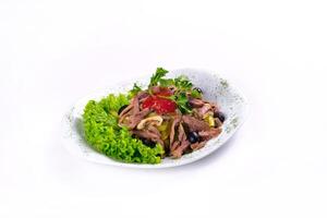 Sliced meat salad with pickled cucumbers and ketchup on an isolated background photo