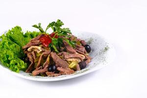 Sliced meat salad with pickled cucumbers and ketchup on an isolated background photo