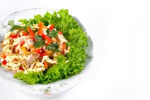 Salad trends. Salad with ham, paprika, pepper and cheese on a white isolated background photo
