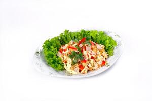 Salad trends. Salad with ham, paprika, pepper and cheese on a white isolated background photo