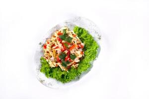 Salad trends. Salad with ham, paprika, pepper and cheese on a white isolated background photo