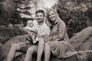 Happy family of three in the summer in the park in nature photo
