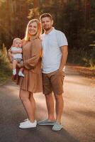 Happy family of three in the summer in the park in nature photo