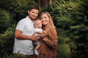 Happy family of three in the summer in the park in nature photo