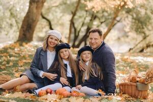 A big family on a picnic in the fall in a nature park. Happy people in the autumn park photo