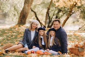 A big family on a picnic in the fall in a nature park. Happy people in the autumn park photo