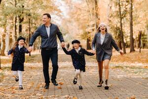 A large family walks in the park in the fall. Happy people in the autumn park photo