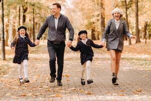 A large family walks in the park in the fall. Happy people in the autumn park photo
