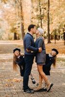 A large family walks in the park in the fall. Happy people in the autumn park photo