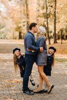 A large family walks in the park in the fall. Happy people in the autumn park photo