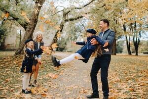 A large family walks in the park in the fall. Happy people in the autumn park photo