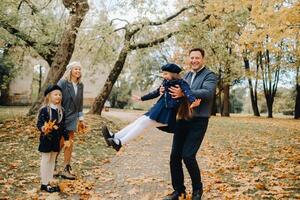A large family walks in the park in the fall. Happy people in the autumn park photo