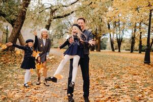 A large family walks in the park in the fall. Happy people in the autumn park photo
