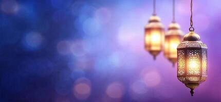 Three lamps hanging from a string on a purple background photo