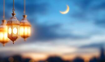 Three lamps hanging from a string with a crescent moon photo