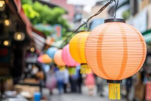 Colorful paper lanterns hanging from a string in a crowded market photo