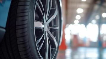 A close up of a car tire in a garage photo