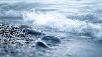Rocky shoreline with a body of water in the background. The water appears to be choppy, with waves crashing against the rocks. Concept of power and movement photo