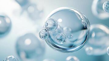 Close up of a clear sphere with many smaller spheres surrounding it. The sphere is surrounded by a blue background photo