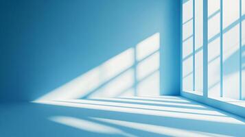 Room with a blue wall and a window. The window is letting in sunlight, creating a warm and inviting atmosphere photo