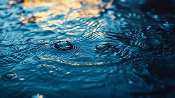The water is calm and still, with ripples forming around the edges. The water is blue and clear, and the ripples are small and gentle photo