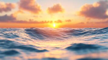 The sun is setting over the ocean, casting a warm glow on the water. The waves are choppy, and the sky is filled with clouds. The scene is serene and peaceful photo