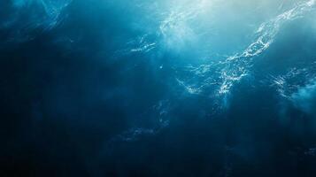 The image is of a body of water with a blue sky in the background. The water is calm and peaceful, with no visible waves or ripples. The sky is clear and bright photo