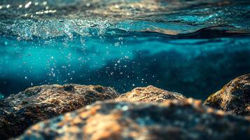Rocky shoreline with a body of water in the background. The water is filled with bubbles and foam, creating a sense of movement and energy. The rocks are scattered throughout the scene photo