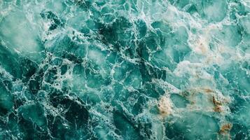 The image is of a body of water with a blue and green color scheme. The water appears to be choppy and has a rocky texture photo
