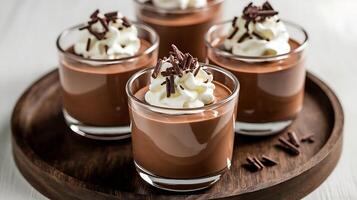 Chocolate pudding in glasses with whipped cream photo