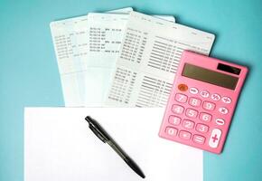 Top view of pink calculators, pen, savings documents, and investing concepts from a financial planner. photo