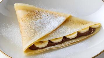 A crepe with chocolate and bananas on top photo