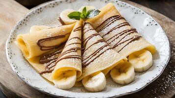 A plate with crepes and bananas on it photo
