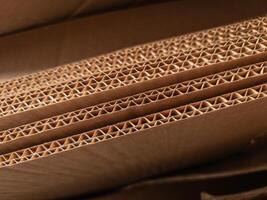 Close-up view of stacked corrugated cardboard layers, showcasing the intricate wave structure and texture, ideal for concepts like packaging, recycling, industry, and material design photo