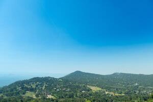 Small houses separated from each other on a mountain range., surrounded by trees. View of landmark of Khao Yai Thieng Windmill Nakhon Ratchasima Thailand. photo