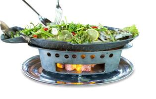 Top view of Steamed Seabass with Lime and Chillies topping with mix vegetable, focus selective photo
