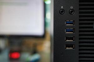 close up of a computer usb port with monitor in background photo