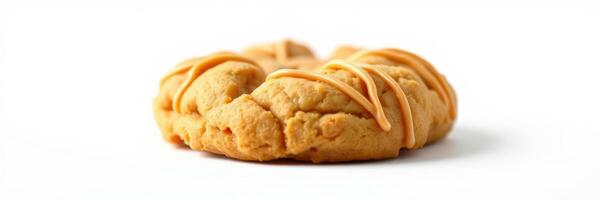 Freshly baked peanut butter cookie decorated with icing on a white background for a delightful treat experience photo