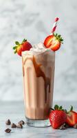 Creamy chocolate milkshake topped with strawberries and whipped cream served in a tall glass photo