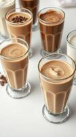 Varied coffee drinks arranged aesthetically on a table with coffee beans scattered photo