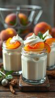 Creamy dessert topped with fresh peach slices and mint leaves served in glass jars on a wooden table photo