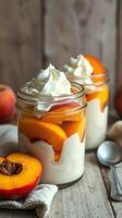 Peach parfaits topped with whipped cream served in jars on a wooden table photo