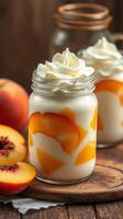 Creamy peach dessert topped with whipped cream in jars on rustic wooden table photo