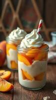 Fresh peach parfaits served in jars with whipped cream and a straw during summer gathering photo
