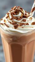 Indulgent chocolate milkshake topped with whipped cream and chocolate shavings in a glass photo
