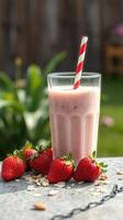 Refreshing strawberry smoothie with fresh strawberries and oats on a stone table photo